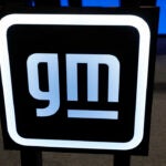 A General Motors sign is seen during an event on January 25, 2022 in Lansing, Michigan. A joint venture between GM and Samsung SDI will bring an EV battery plant worth more than $3B to Indiana. (Photo by JEFF KOWALSKY/AFP via Getty Images)
